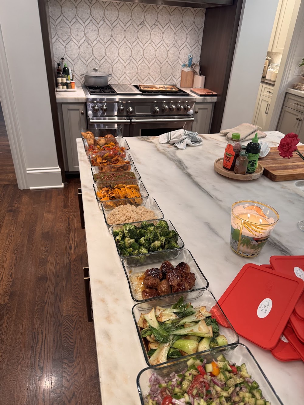 A full week of meal prep laid out on a marble island