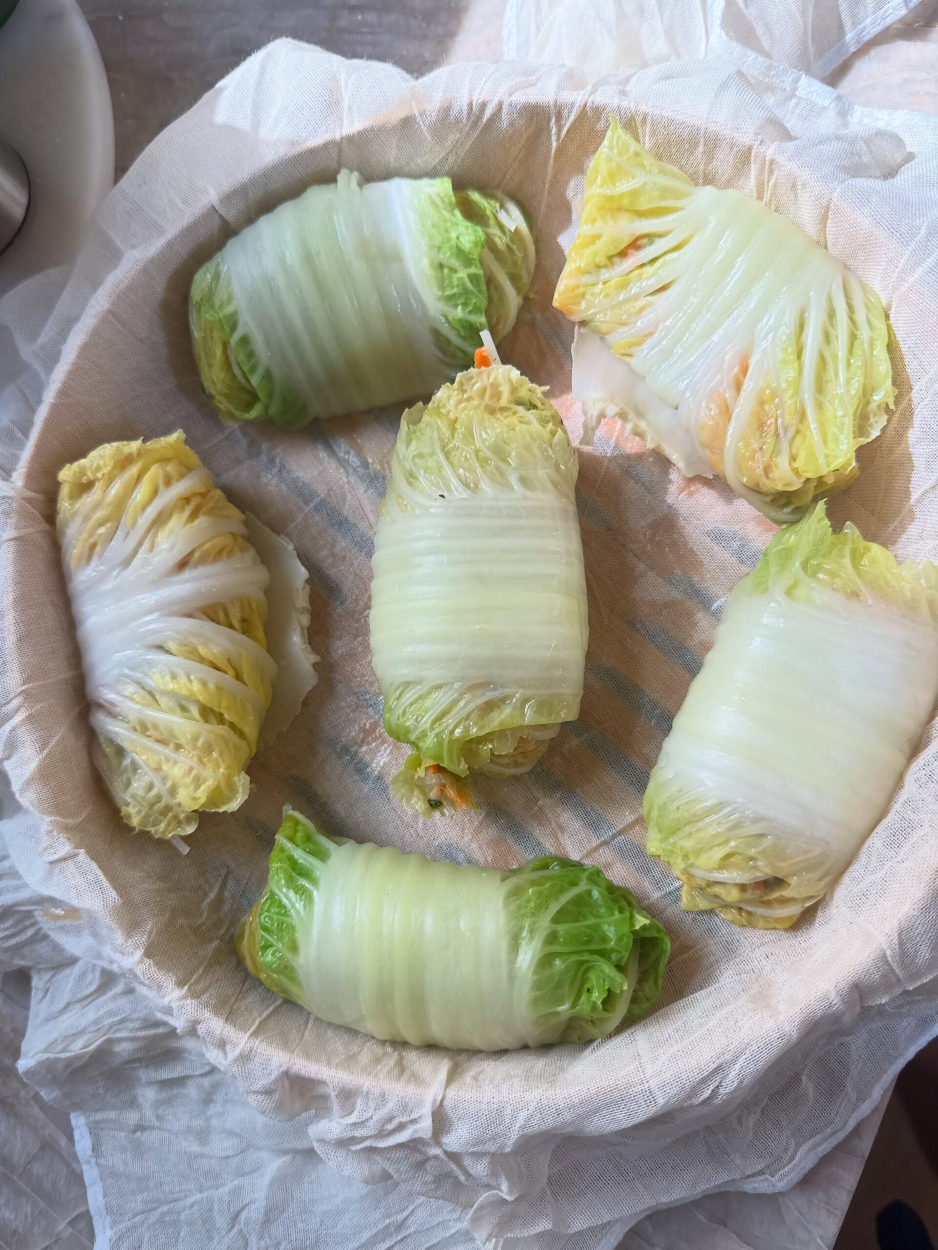 Napa cabbage rolls on parchment