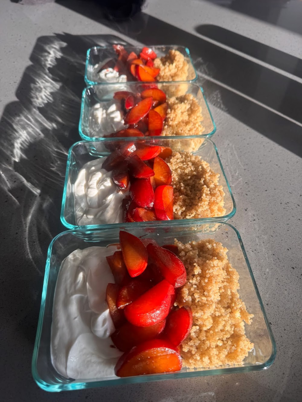 Meal prep bowls with yogurt, fresh fruit and quinoa