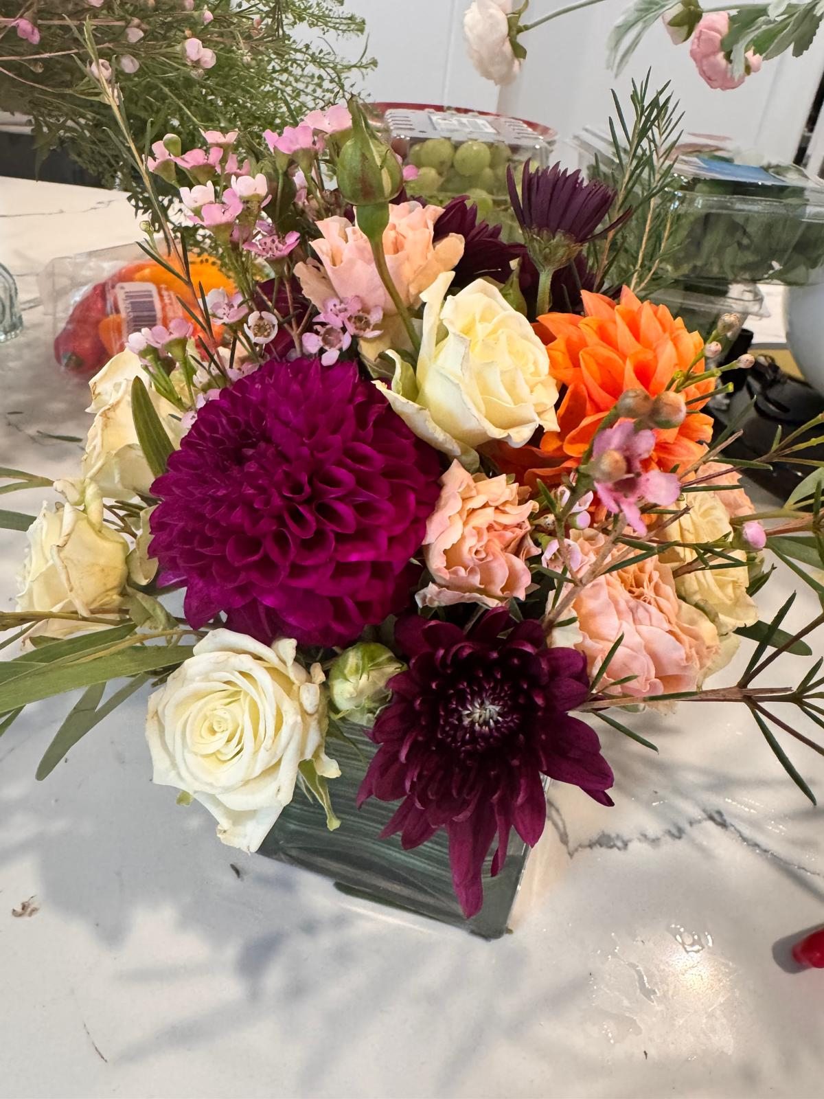 Services Centerpiece of dahlias, roses and garden flowers