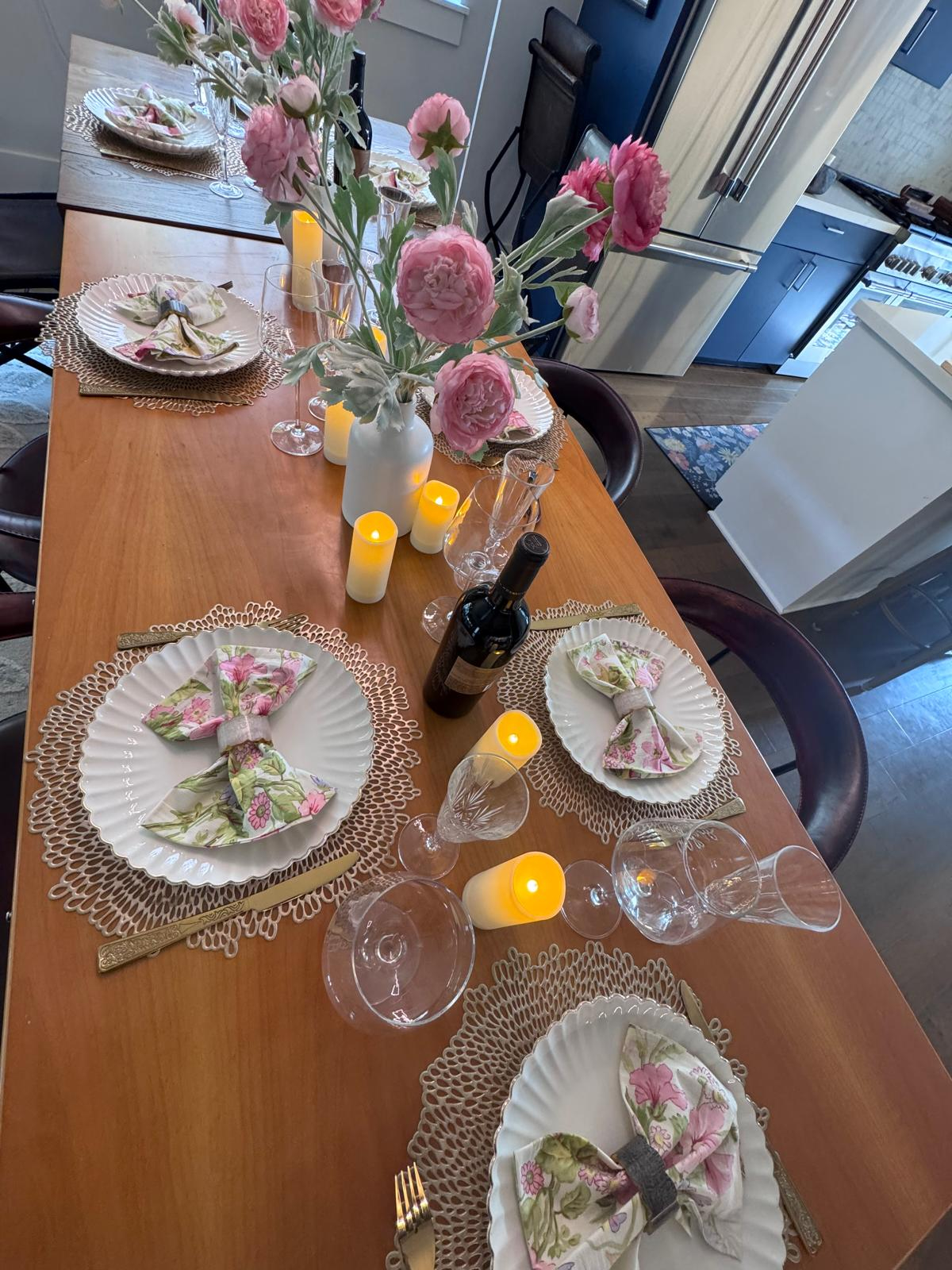 Services Spring dinner table with pink flowers and floral napkins